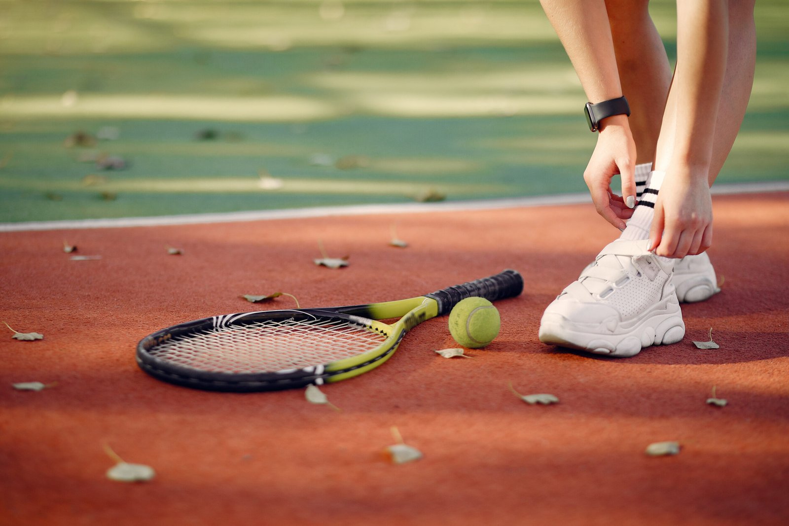 Girl on the tennis court. Woman  in a sports clothes.